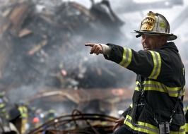 uniformed firefighter pointing straight