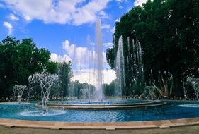 fountain with water splashes in summer park, hungary, budapest