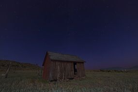 ruined farm building in countryside at night