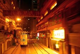 tram on street in night city, china, hong kong