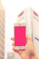 iphone with pink screen in hand