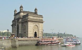 boats and tourists at gateway of india monument, mumbai