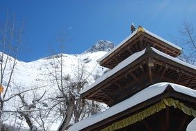 roof of buddhist pagoda at snowy mountain