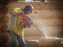 worker cutting log with chainsaw