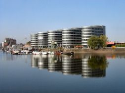 Office complex and boats at harbour, germany, duisburg