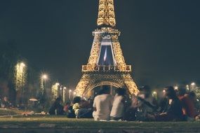 people looking at lightened eiffel tower, paris, france