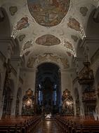 painted ceiling, benches and altar in church interior, germany