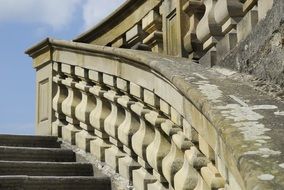 old stone stairway with balustrade at sky