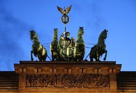 quadriga atop brandenburg gate at dusk, germany, berlin