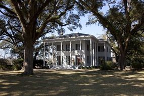 White mansion in trees historic landmark