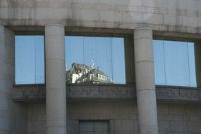 mirroring of building on window, spain, madrid