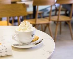 a cup of cappuccino coffee in a restaurant