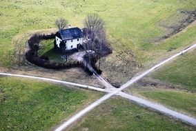 top view of white house near road crossing at winter