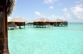 wooden buildings on piles in water, maldives