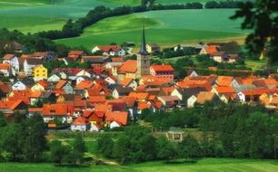 scenic old town with red roof buildings in green countryside, germany, bavaria, burglauer