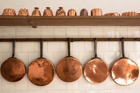 old georgian style copper pans and baking moulds on kitchen