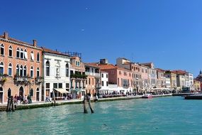 people resting on colorful waterfront, italy, venice