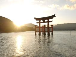 famous torii at Itsukushima Shrine at sunset, japan