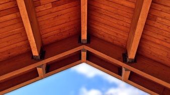 wooden roof at blue sky, bottom view