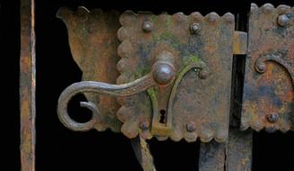 antique forged door handle and key hole close up