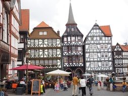 people on marketplace at guild house, germany, fritzlar