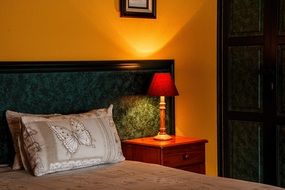 Comfortable bedroom with lamp