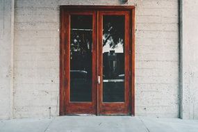 vintage entrance door with glass in concrete wall