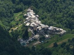 top view of village among forest in mountain valley, italy, liguria, verdeggia