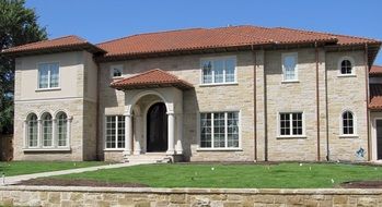 old mansion with porch and red tile roof