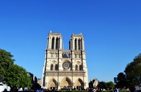 people in park at notre-dam cathedral in france, paris