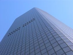 low angle view of tall office building at blue sky