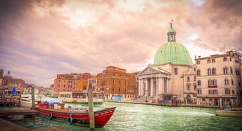 colorful boats on channel in view of landmarks, italy, venice