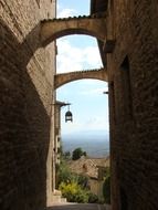 old narrow alley with bridges between buildings, italy, sicily