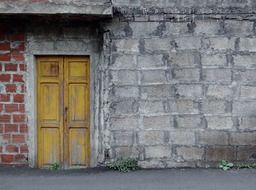 yellow wooden door in old facade