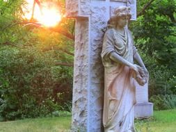 Stone angel sculpture on the cemetery On the Sunset