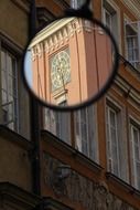 antique clock on tower, reflection in mirror, poland, warsaw
