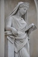reading woman with pencil, sculpture