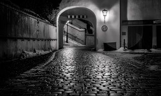 cobblestone path on street of old town at night