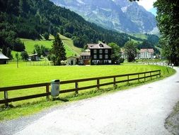 summer mountain landscape with village at road, switzerland