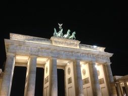 top of illuminated brandenburg gate at night sky, germany, berlin