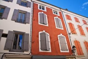 terraced houses with shutters at windows on colorful facades