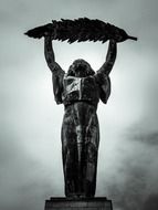 bronze Statue of Liberty at clouds, hungary, budapest