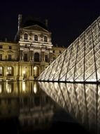 louvre pyramid with reflection at night, france, paris