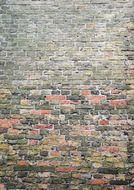 surface of old grey and red brick wall of house