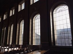 tables and chairs in interior of old building with grated windows, uk, england, london, greenwich