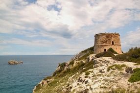 medieval watchtower on rocky coast at sea