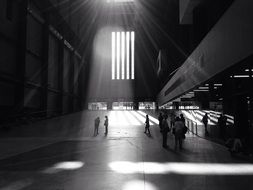 people in big modern hall, england, london