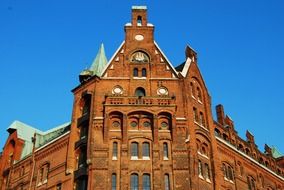 top of kontorhaus facade with copper roof at blue sky, germany, hamburg, speicherstadt