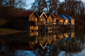 wooden sheds on ammersee lake coast at dusk, germany, bavaria