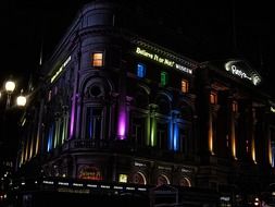 colorful illuminated building on piccadilly circus at night, uk, england, london